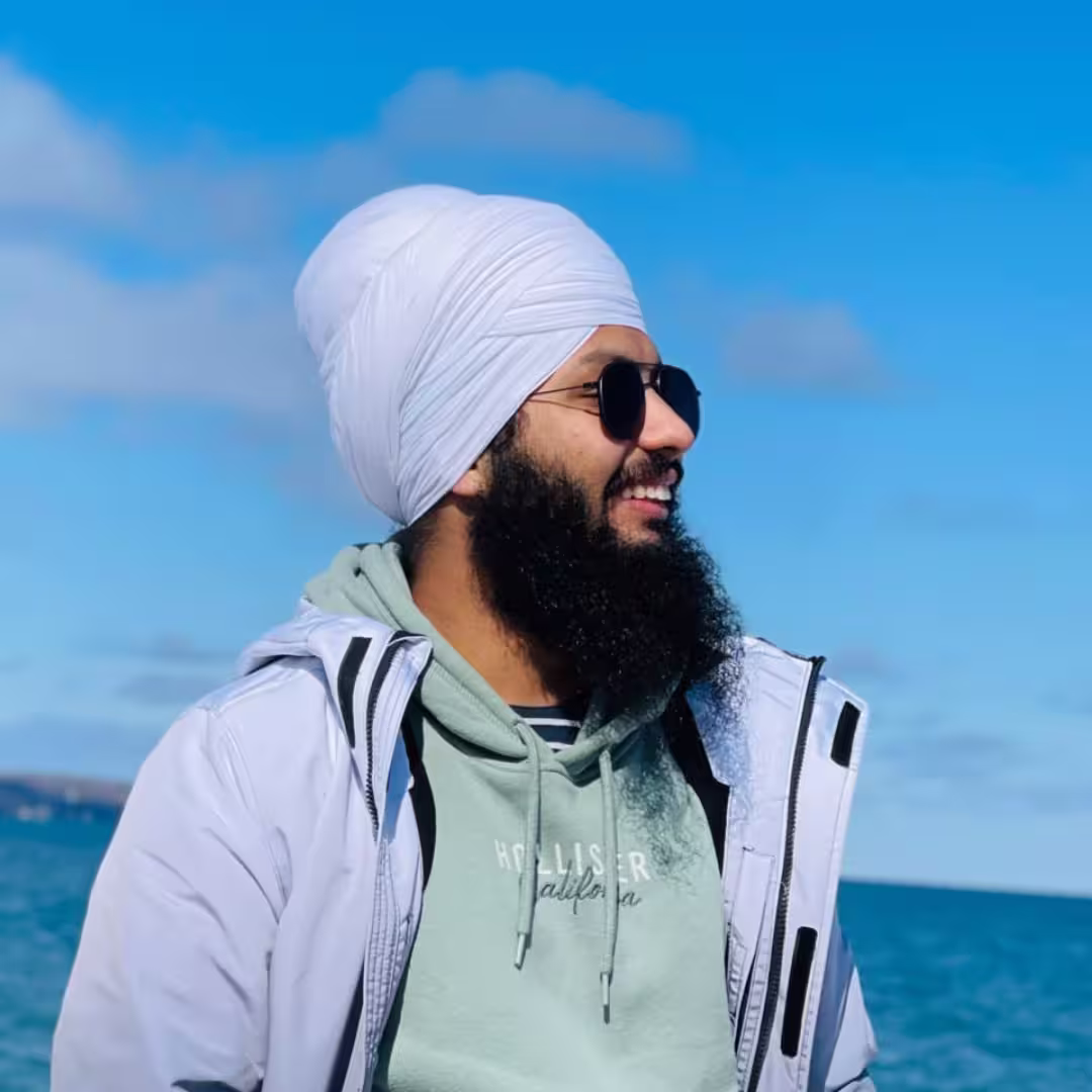Jaspreet Singh, owner of Kesri Contractors in Scarborough, Ontario, smiling outdoors near the ocean, representing trust and professionalism in home maintenance services